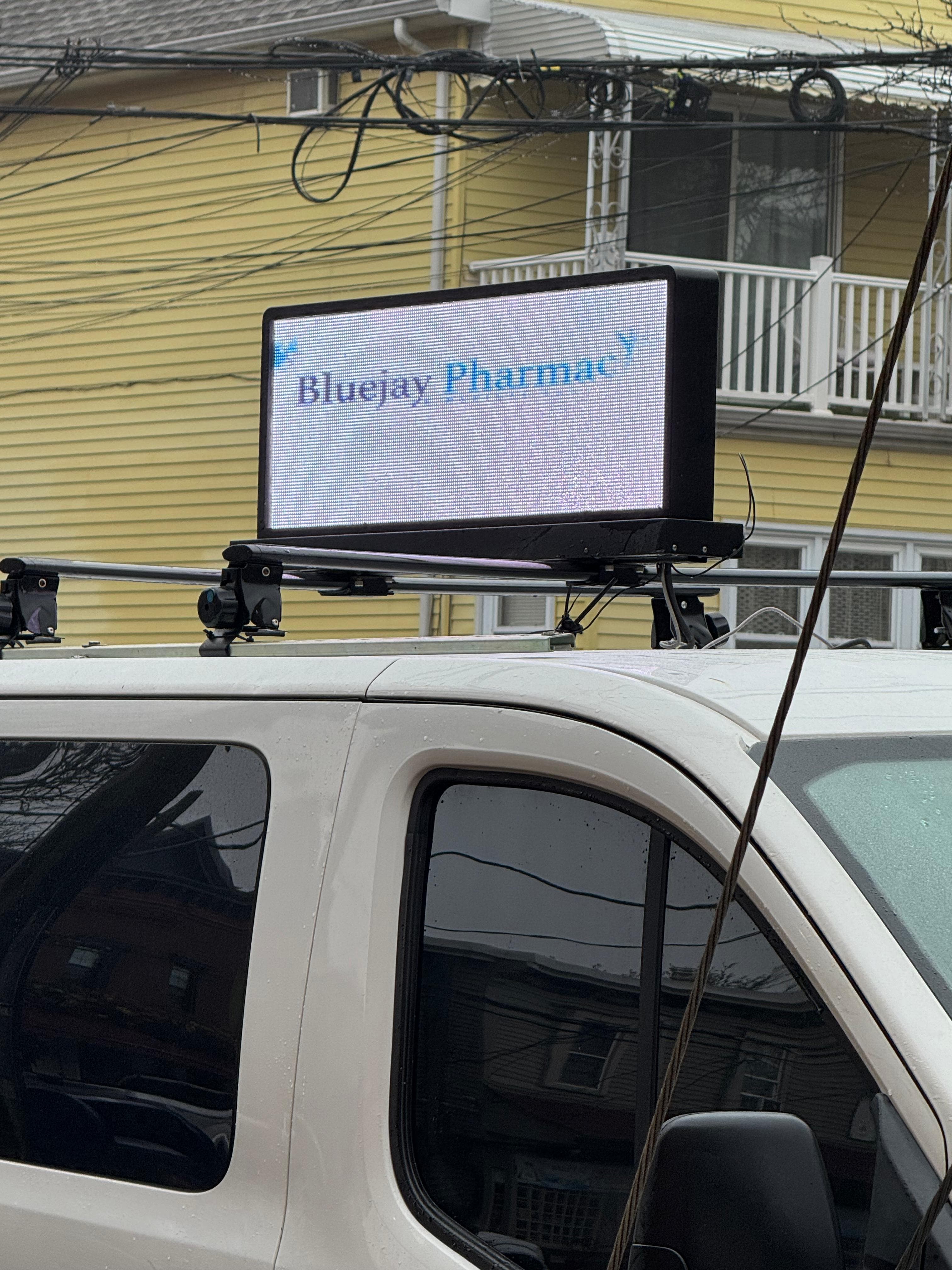 Blue Jay Pharmacy advertisement displayed on LED van screen